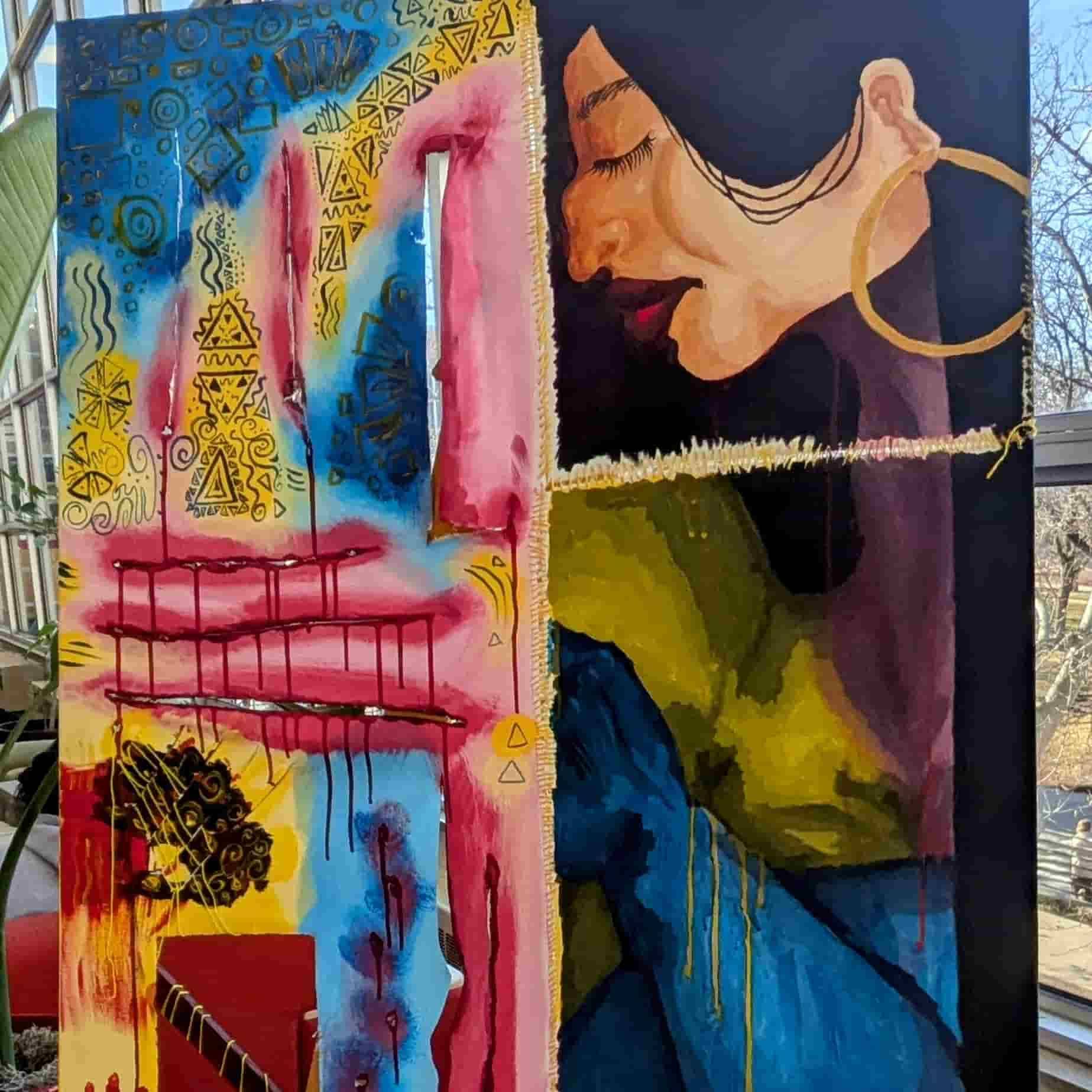 A canvas depicting a native woman's face and artistic indigenous designs
