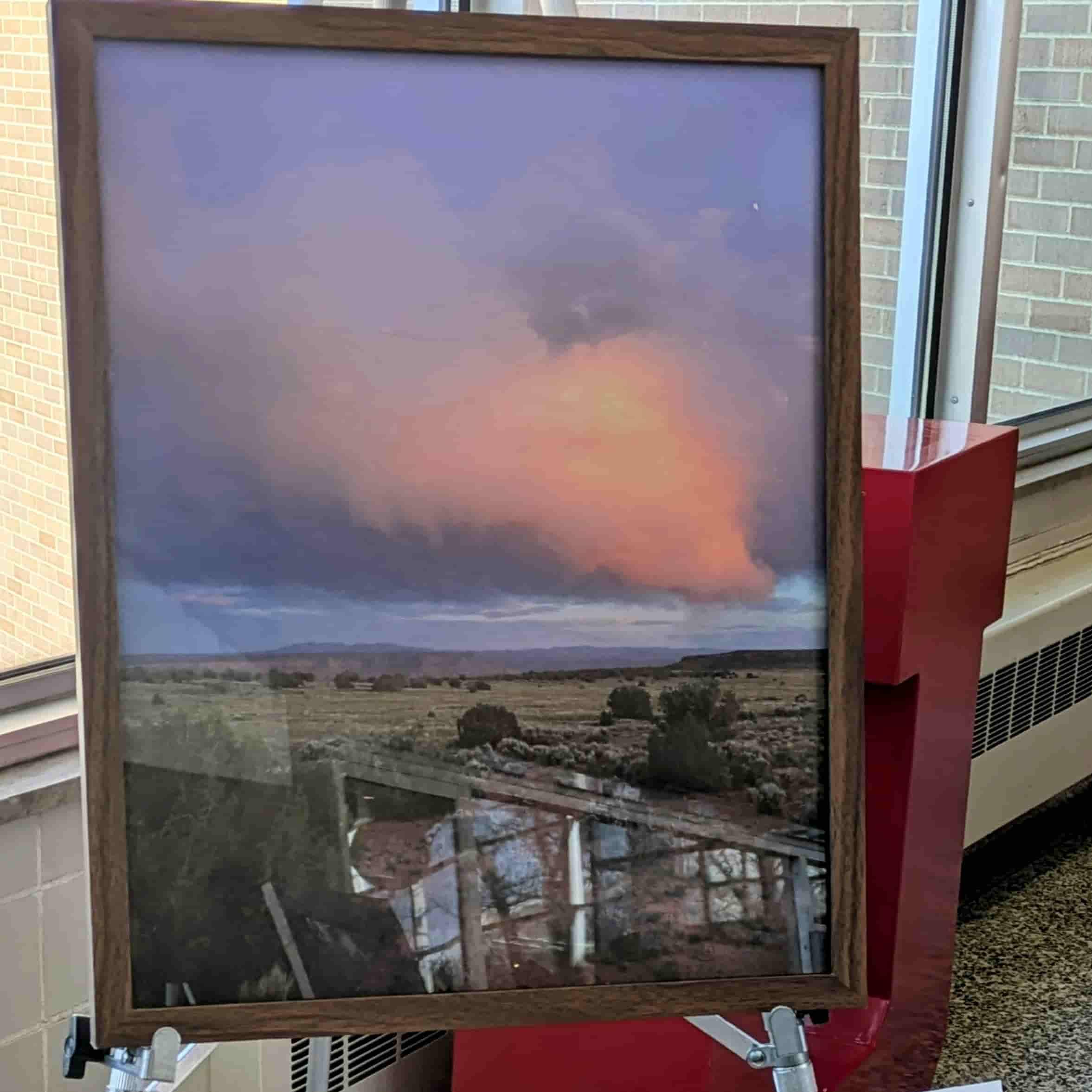 A photo in a frame of a desert landscape at sunset